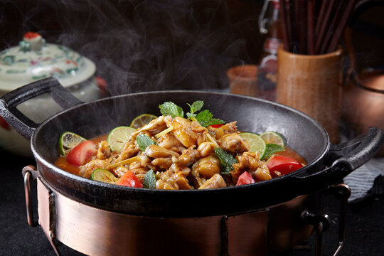 Wok-fried frog meat with tomatoes, close-up