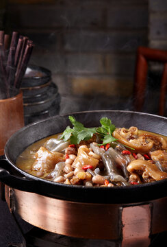 Wok-fried pig's trotters with peanuts, close-up.