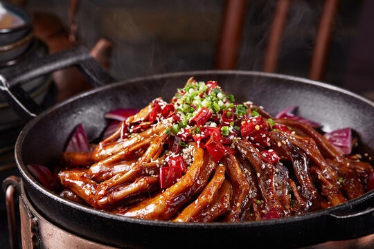 Wok-fried spicy braised duck feet, close-up