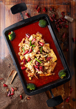Spicy Garlic Braised frog in a Wok on table
