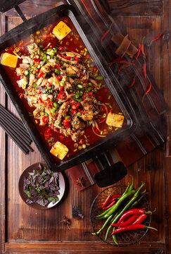 Spicy braised frog in a wok.