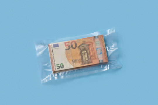 Vacuum sealed fifty euro stack on blue