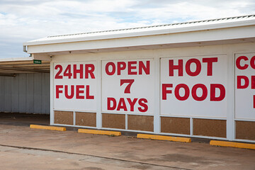 Gas station signage with services in red and white