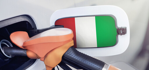 Italy flag on the lid of the gas tank of a car at a gas station in close-up. High or low gasoline prices at Italian gas stations. Gasoline prices are rising due to a shortage of diesel fuel