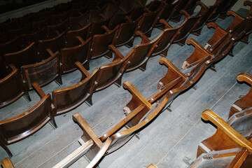 Empty wooden seats filling an old auditorium
