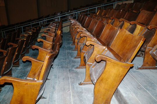 Empty wooden seats creating lines in a vintage theater