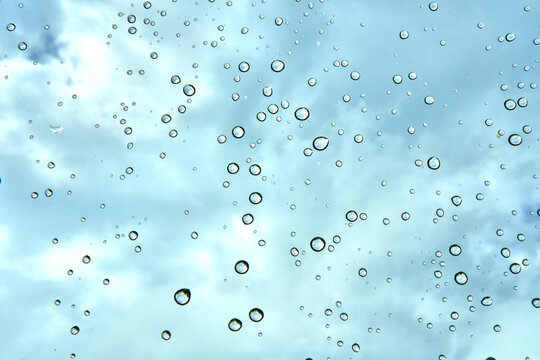 Raindrops on a Window against a Blue Sky