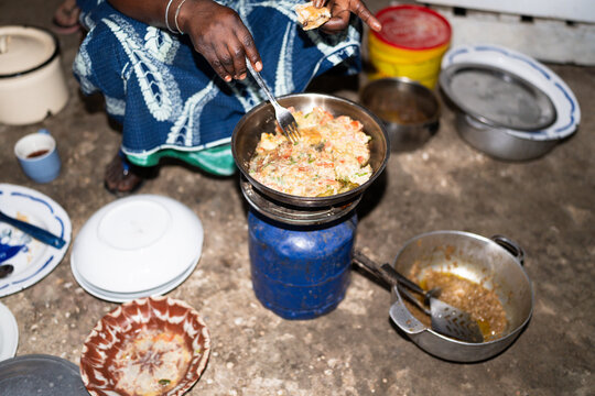 Senegalese woman cooking traditional meal in Senegal, Africa