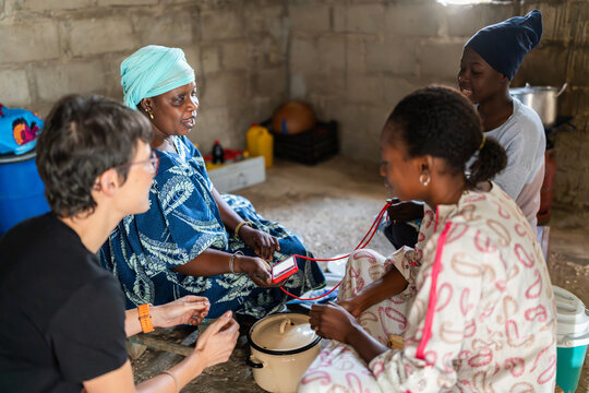 Volunteer showing new technology to local women in Senegal, Africa
