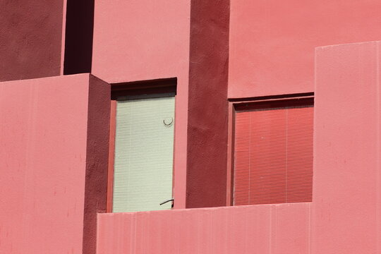 Asymmetrical windows in a pink building