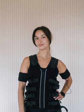 Young Woman in EMS Suit Post Workout