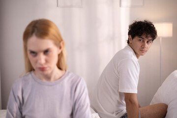 Obraz premium Couples who are angry at each other, fighting in bed, feeling frustrated, sad, divorce or relationship problems, marital stress, quarrels and arguments, unhappy spouses, and sexual dysfunction.