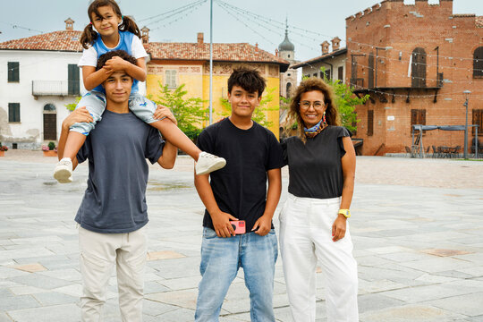 Fototapeta Family Enjoying a Sunny Day in a Charming Italian Square
