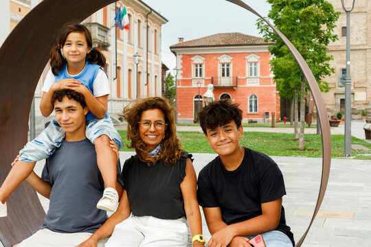 Family Enjoying a Sunny Day in a Town Square 