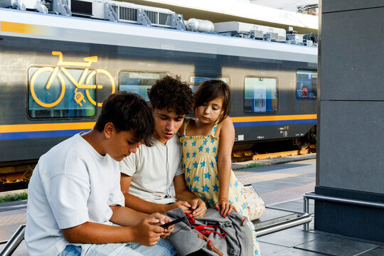 Children Engaged in Activity at a Train Station Platform