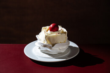 Meringue Dessert with Cream and Red Ball Topping