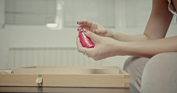 Watch a woman's hands meticulously stack and arrange backgammon checkers, capturing the crisp. This video highlights the tactile experience and distinct audio of board game play at home.
