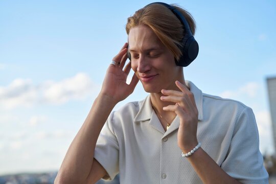 Enjoying Music on a Breezy Day in an Urban Landscape