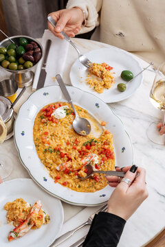 People sharing crab risotto at a restaurant table
