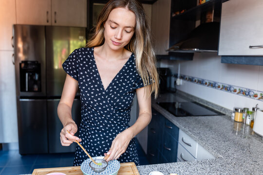 Woman measuring tea powder