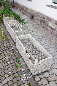 Empty flower box on the sidewalk