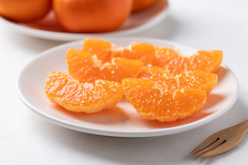 Fresh cut of Mandarin orange fruit on plate ready to eating