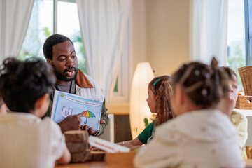 Teacher instructs children using a letter "U" worksheet.
