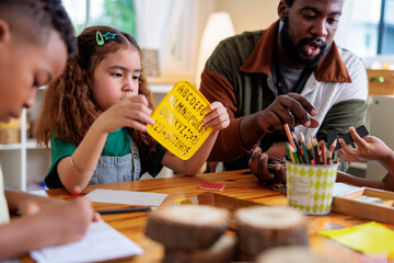 Teacher helps children learn letters and numbers.