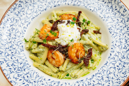 Creamy pasta with shrimp, sun-dried tomatoes, and burrata