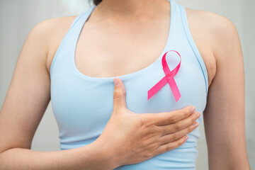 Breast cancer, pink ribbon at Asian senior lady for supporting awareness, symbol of World Breast...