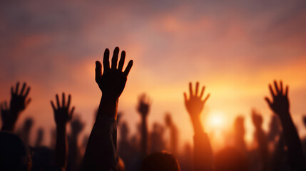 People raising hands air during sunset, creating silhouette scene with vibrant sky, evoking feelings of unity, celebration