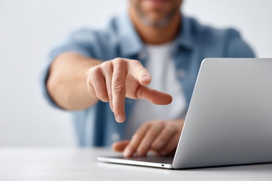 Man Pointing at Laptop Screen, Engaging User Interaction, Business Presentation, Technology Concept, Action Oriented