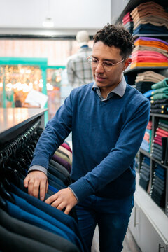 Man browsing jackets in menswear boutique