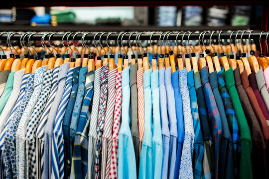 Colorful patterned shirts hanging in clothing store