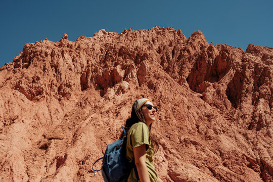Young woman hiking in desert mountains with red rock formations