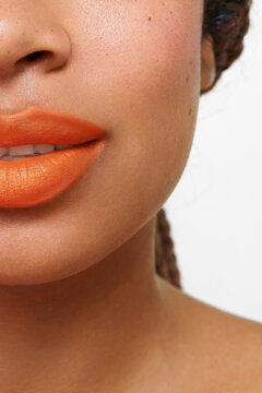 Extreme close-up of orange lipstick on lips