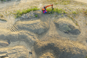 Excavator Clearing Debris on Construction Land