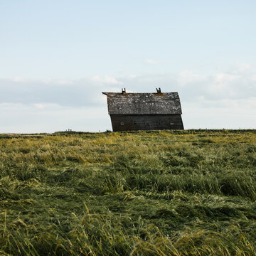 Abandoned wooden house in ghost town prairie