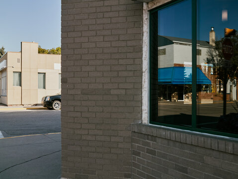 Reflections of small town street in building window