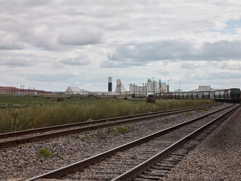 Railway tracks leading to potash plant with freight cars