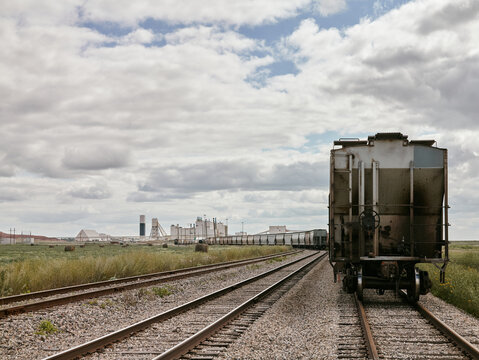 Freight train cars on railway tracks near potash plant