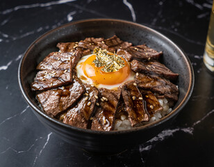 Wagyu don rice bowl with seared beef, egg yolk, and gold leaf