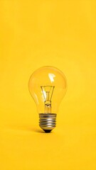 Illuminating Ideas - A Light Bulb Against a Yellow Backdrop.
