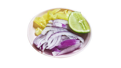 Fototapeta premium Close-up of a side dish with thinly sliced red onion, pickled mustard greens, and a fresh lime wedge, served as a condiment or garnish