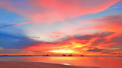 Sea sunset, tropical island beach sunrise, beautiful ocean panorama landscape, colorful red orange pink yellow sky clouds over water, golden sun light, summer holidays, travel