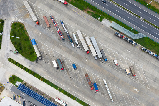 Aerial view of trucks and trailers parked in highway service area
