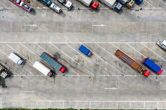 Aerial view of trucks and trailers parked in highway service area