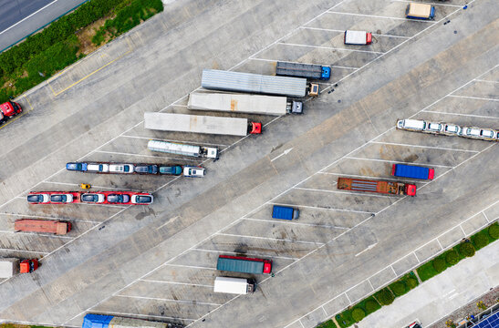 Aerial view of trucks and trailers parked in highway service area