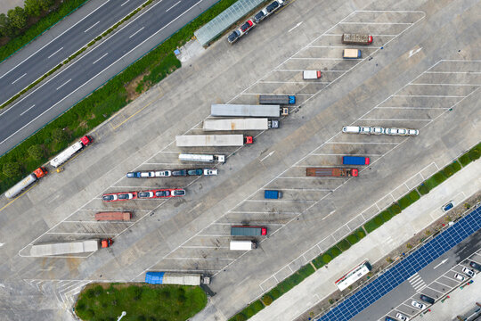 Aerial view of trucks and trailers parked in highway service area