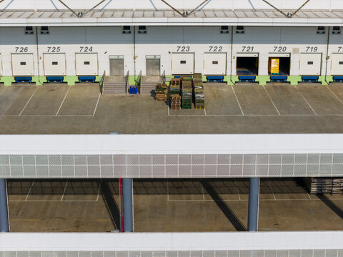 Logistics Warehouse Loading Dock with Numbered Bays and Pallets